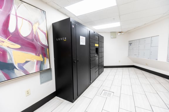 a row of black elevators in a white room with a painting on the wall at ParcOne60, Reno, NV