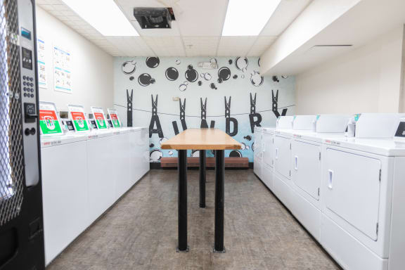 a washer and dryer room with a table in the middle at The Onyx at 695, Reno, NV