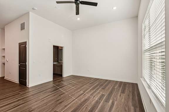 A room with a ceiling fan and wooden flooring at The Stadler Luxury Apartments, Florida 34210