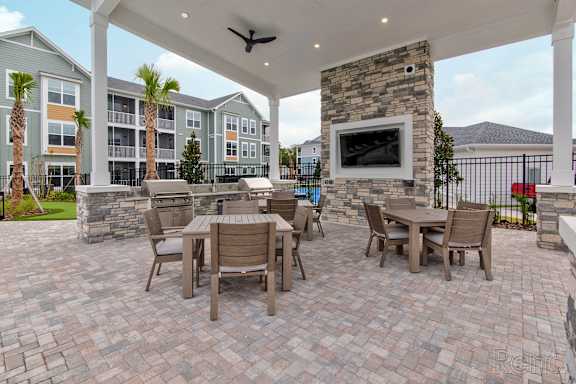 A patio with a table and chairs at Standard441 Luxury Apartments, Lady Lake