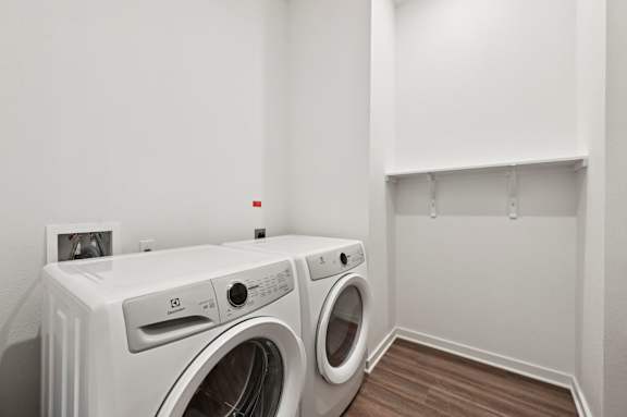 A white washing machine and dryer in a laundry room.
