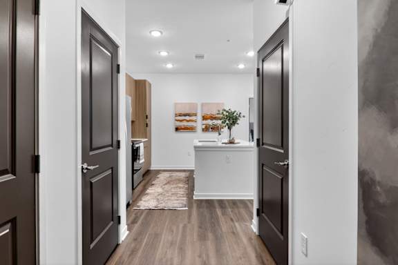 A hallway with a rug and a framed picture on the wall.at The Logan Luxury Apartments, Idaho, 83651