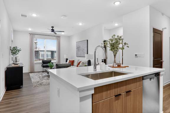 A modern kitchen with a large island and a dining area with a view of the city.at The Logan Luxury Apartments, Idaho, 83651