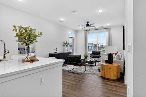 A living room with a white countertop and a black couch.at The Logan Luxury Apartments, Idaho, 83651