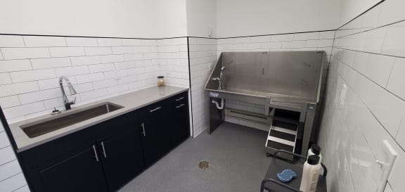 a kitchen with a sink and a stove in it at The BLVD at Wilson Crossings, Wyoming, MI