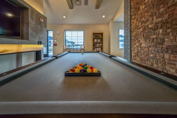 a billiards room with a pool table and a basket of balls at The BLVD at Wilson Crossings, Wyoming, 49418