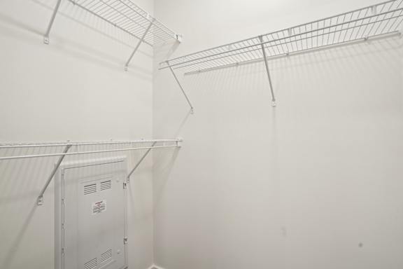 A white refrigerator is in a room with white walls.