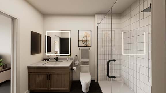 A modern bathroom with a white toilet, a sink, and a large mirror.