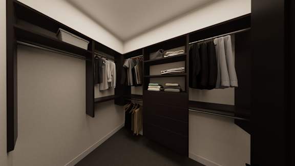 A walk in closet with clothes hanging on shelves and hanging rails.
