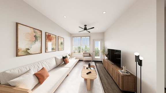 A living room with a white sofa, a wooden coffee table, and a television.