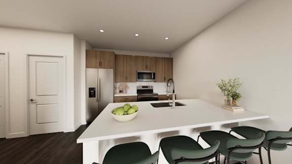A modern kitchen with a white table and green chairs.