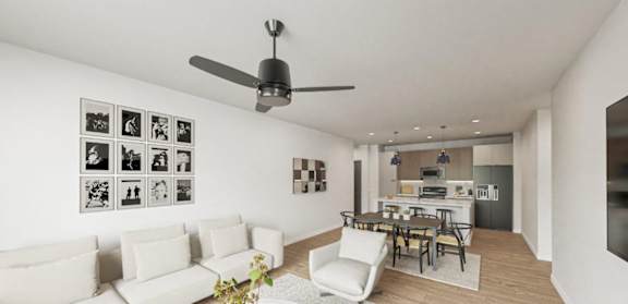 A modern living room with a white couch and a ceiling fan.