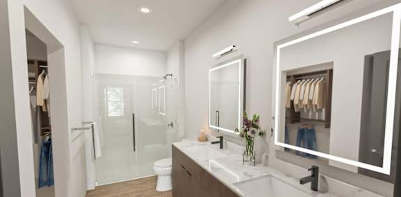 A modern bathroom with a walk-in shower and double sinks.