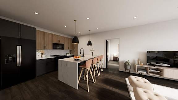 A modern kitchen with dark wood floors and a dining table set for two.