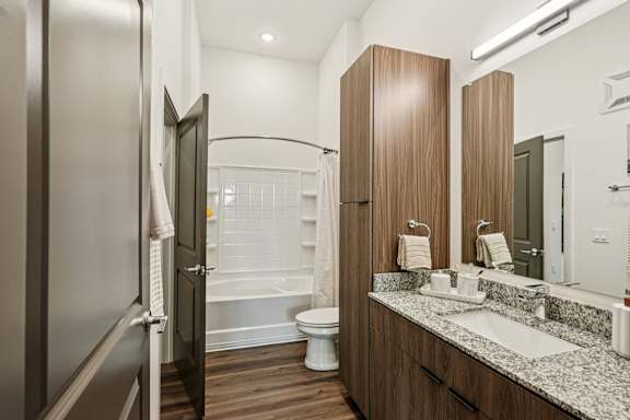 A bathroom with a toilet, sink, and mirror at The Stadler Luxury Apartments, Bradenton, 34210