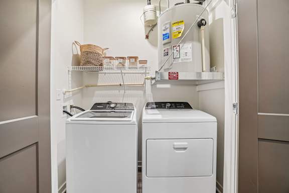A white washing machine and dryer in a small laundry room.