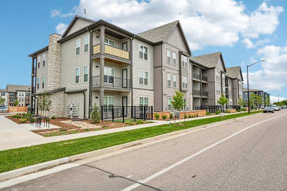 A street view of a residential area with apartment buildings.