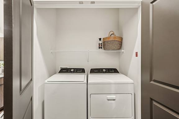 A small laundry room with a washer and dryer at The Stadler Luxury Apartments, Bradenton, FL 34210