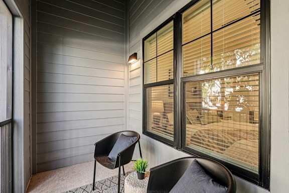 A chair sits on a porch at The Stadler Luxury Apartments, Bradenton, 34210