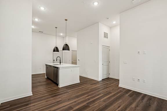 A kitchen with a white cabinet and a sink is shown at The Stadler Luxury Apartments, Florida 34210