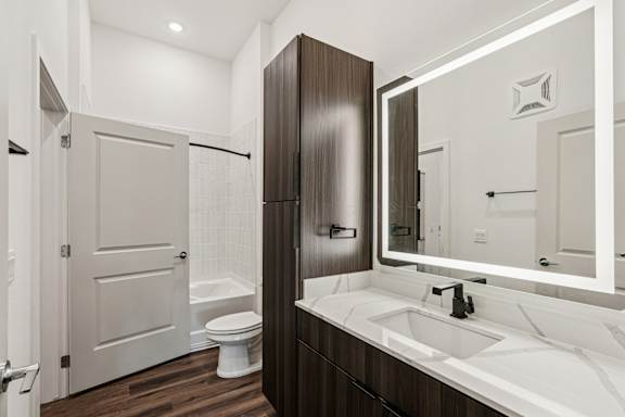 A bathroom with a white sink and a white toilet at The Stadler Luxury Apartments, Bradenton