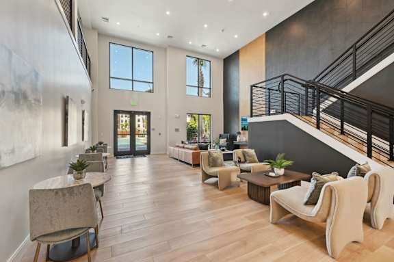 A spacious living room with a staircase on the right side. at The Concord Luxury Apartments, Florida, 34240