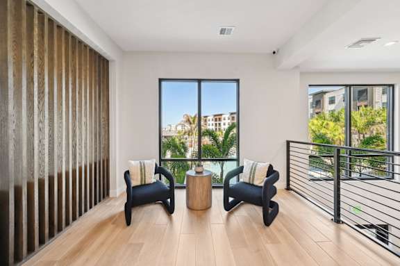 A modern living room with a view of the city. at The Concord Luxury Apartments, Florida
