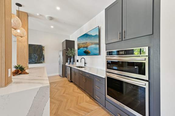 A modern kitchen with a marble countertop and stainless steel appliances. at The Concord Luxury Apartments, Sarasota, FL, 34240