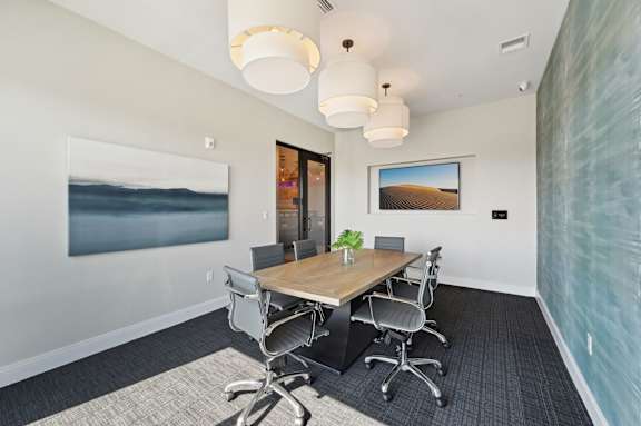 A conference room with a long table and chairs. at The Concord Luxury Apartments, Florida