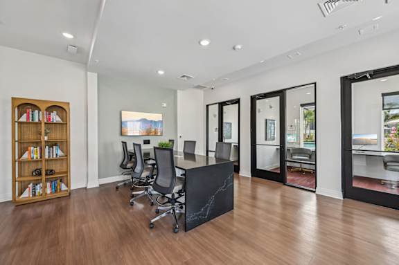 A room with a black table and chairs with a view of the outside at The Hadley - North Port, FL Apartments, Florida, 34287