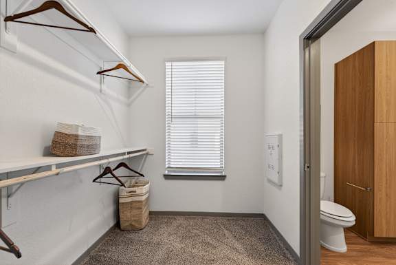 A small, white room with a toilet and a window with blinds.at Refinery at Pointe17 Apartments, Phoenix, AZ, 85085