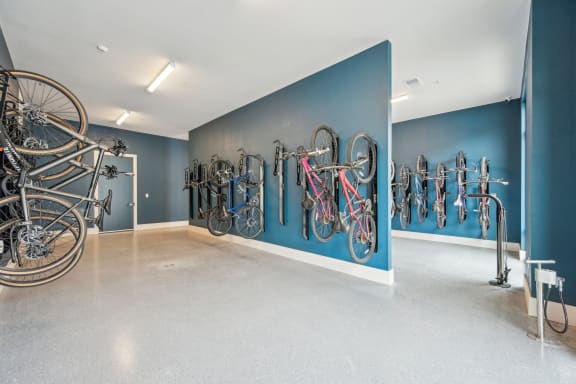 a room with bikes hanging on a blue wall at The Quarry Luxury Apartment Homes, Fort Collins, CO