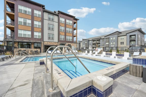 our apartments have a large swimming pool in front of our buildings at The Quarry Luxury Apartment Homes, Fort Collins, Colorado