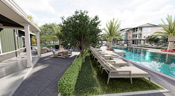 A poolside area with lounge chairs and a tree in the middle at Verity Luxury Apartment Homes Apartments, Vero Beach, Florida