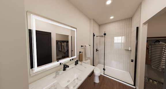 A bathroom with a marble sink and a walk-in shower.