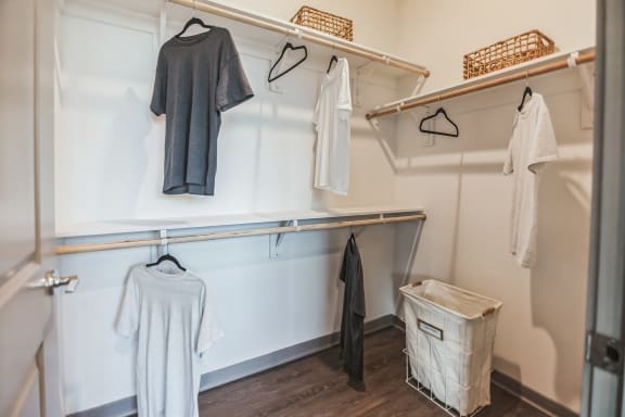 a walk in closet with white walls and wooden floors  at Palm Grove, Ellenton, FL, 34222