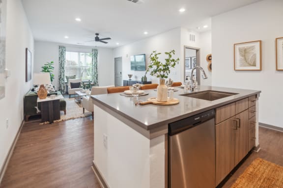 a kitchen with an island and a living room with a couch  at Palm Grove, Florida, 34222