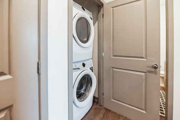 a washer and dryer in a small laundry room with a door  at Palm Grove, Ellenton, FL, 34222