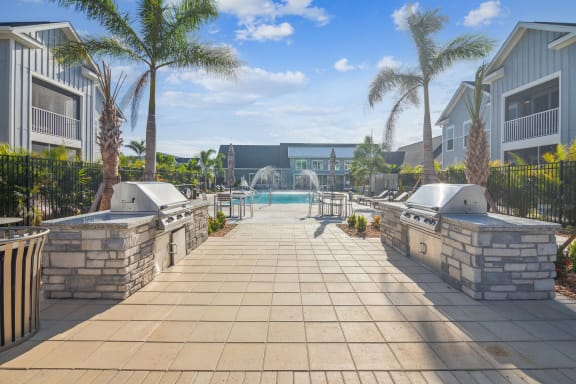a resort style pool with two hot tubs and palm trees  at Palm Grove, Ellenton, FL, 34222