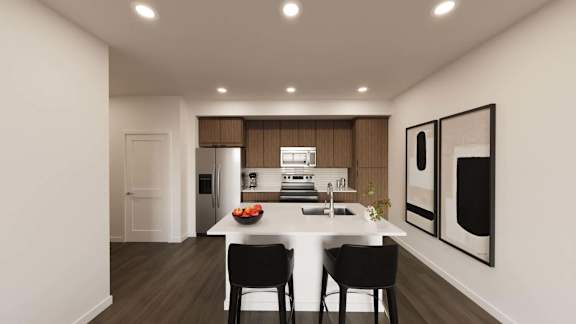 Open kitchen with island seating and wood cabinetry at The Maverick Luxury Apartments, Monument, CO