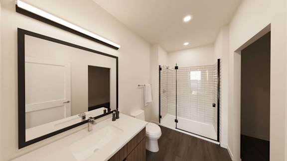 Bathroom with glass shower and framed mirror at The Maverick Luxury Apartments, Monument