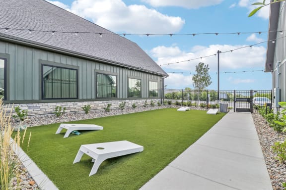 the backyard of a house with a lawn and picnic tables at The Depot in The Depot Raymore, MO 64083