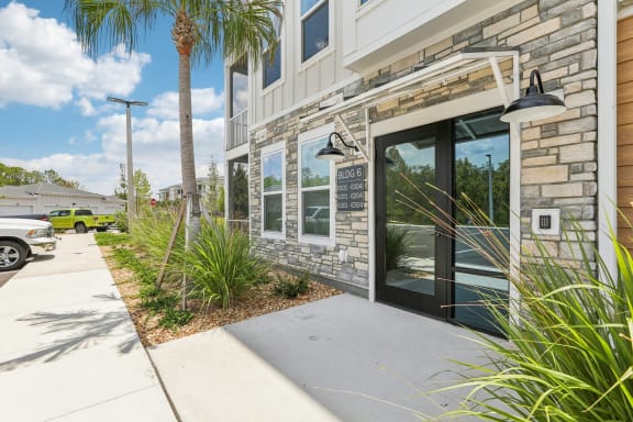 the front of a building with glass doors and a sidewalk at Drift, Daytona Beach, FL, 32117
