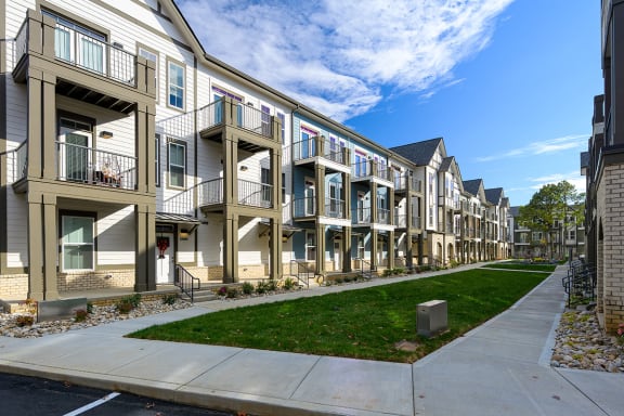 a row of town houses with balconies and a sidewalk  at Oakbrook Townhomes, Tennessee, 37067