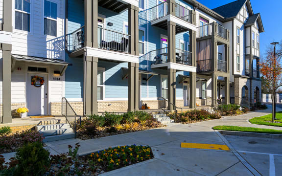 a row of apartments with balconies and a sidewalk  at Oakbrook Townhomes, Franklin