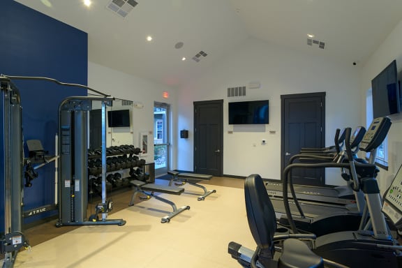 a gym with cardio equipment and a tv on the wall  at Oakbrook Townhomes, Franklin, 37067