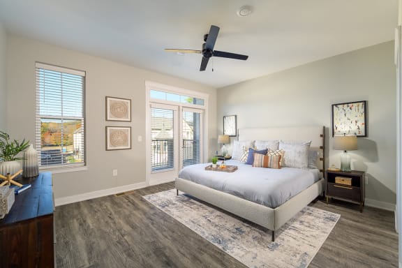 a bedroom with a large bed and a ceiling fan  at Oakbrook Townhomes, Tennessee, 37067
