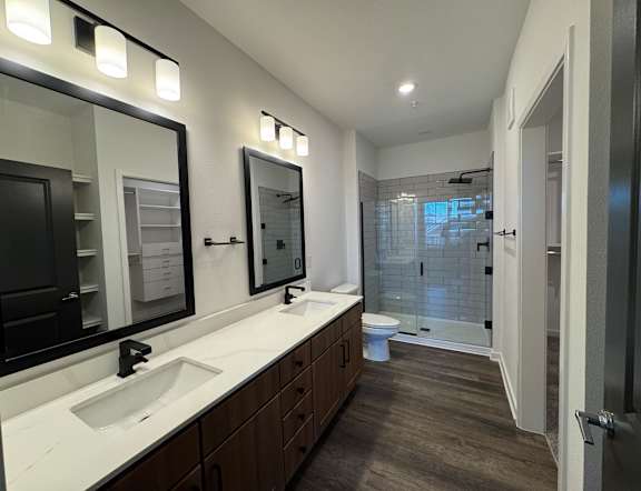 A bathroom with a white sink and brown cabinets. at The Junction at Rockledge Apartments, Florida, 32955