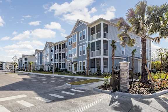 A large apartment complex with a parking lot in front at Standard441 Luxury Apartments, Florida, 32159