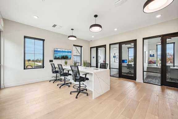 A conference room with a long table and chairs.at The Garrison Luxury Apartment Homes, Fountain, 80817